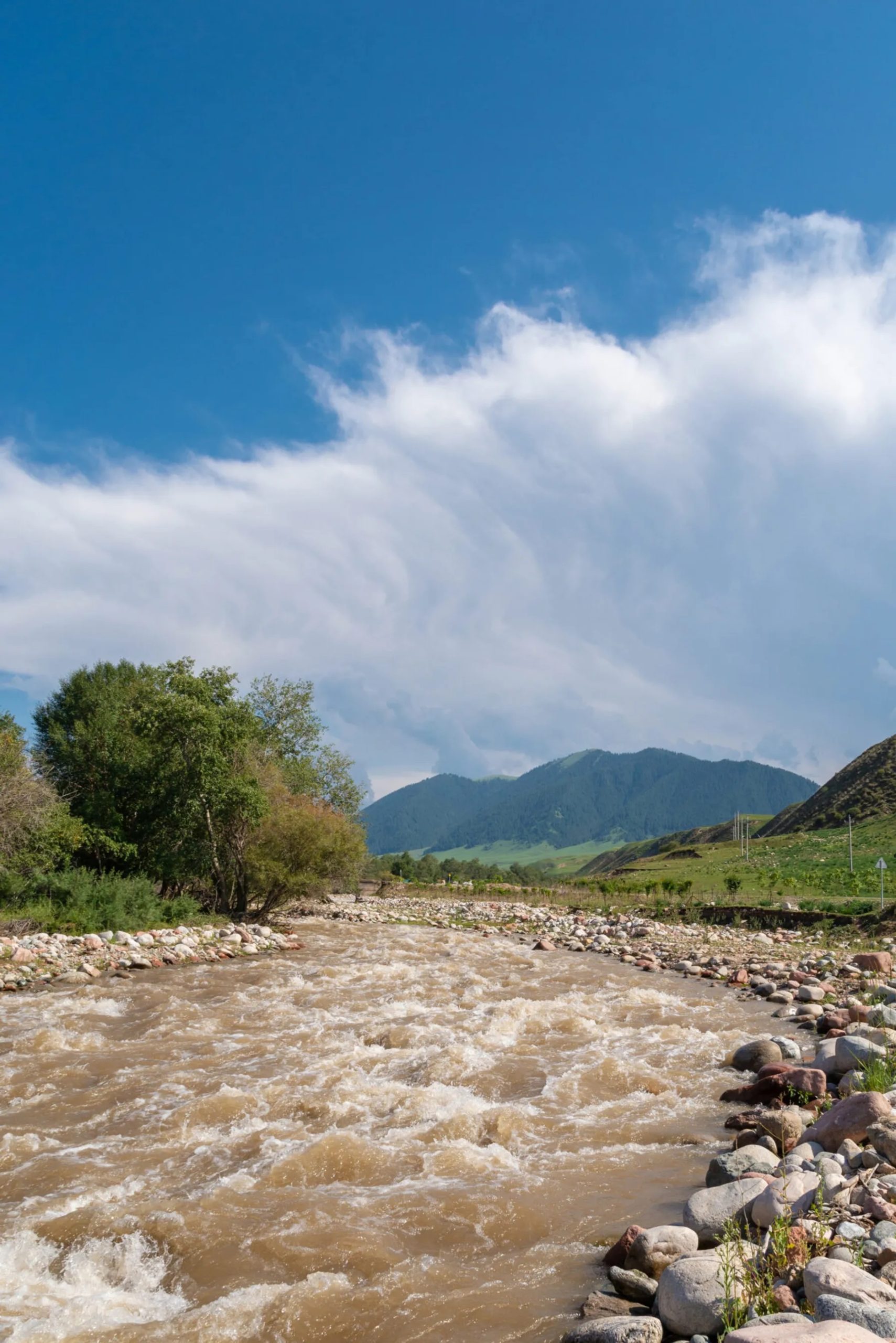 95a7e46a-rushing-muddy-river-under-cloudy-sky-1209360580-scaled