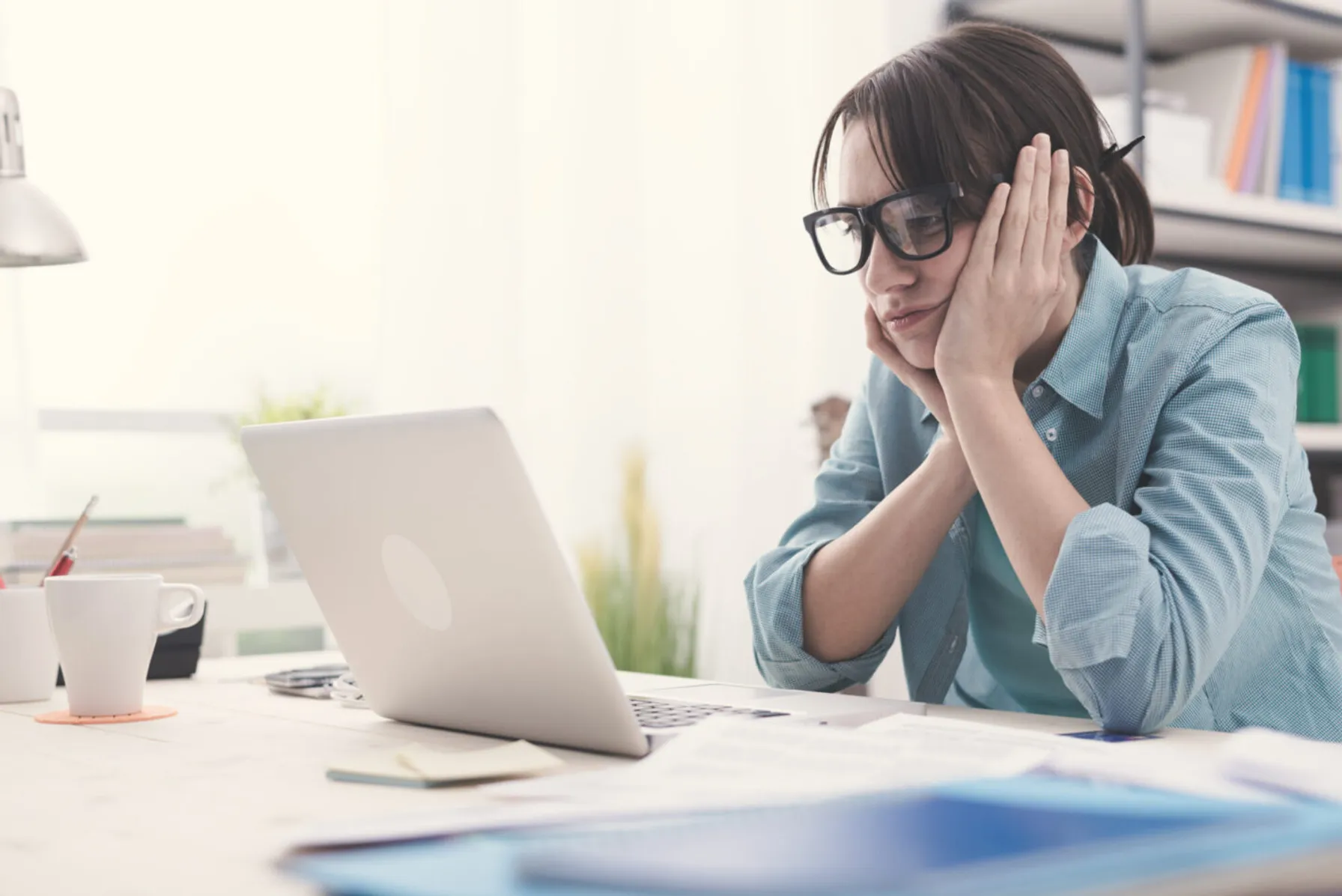 7eab88f6-bored-woman-working-with-her-laptop-585049820-1440x961-1