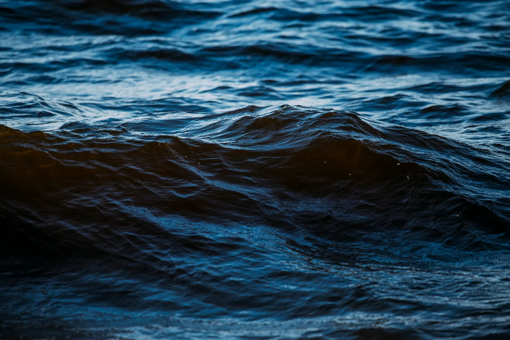 64d83b40-dark-blue-waves-in-the-water-1253853268