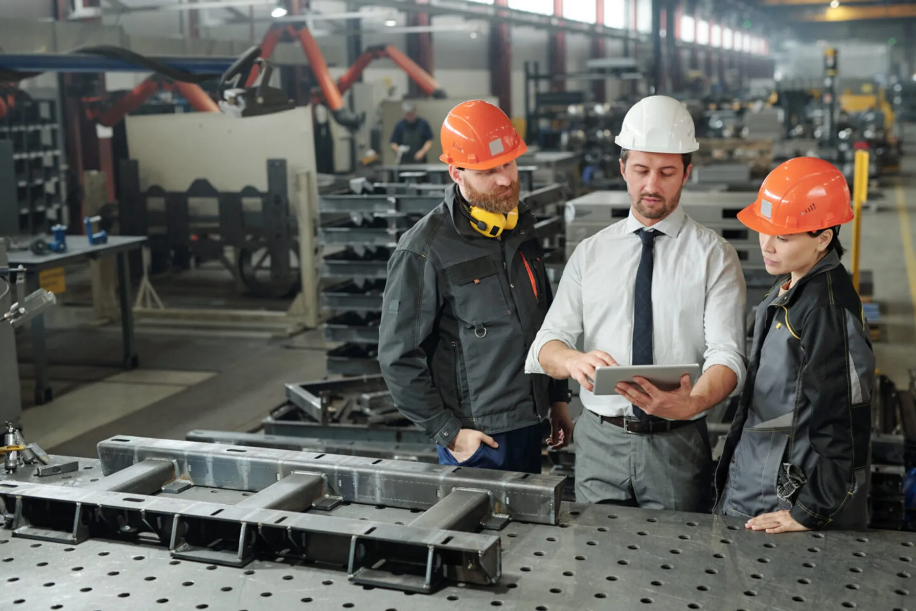 688d66cf-engineers-showing-his-colleagues-online-data-in-tablet-1207928632-1440x960-1