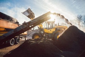 8ea91900-heavy-machinery-moving-earth-and-biomass-in-compost-works-1218842839-min