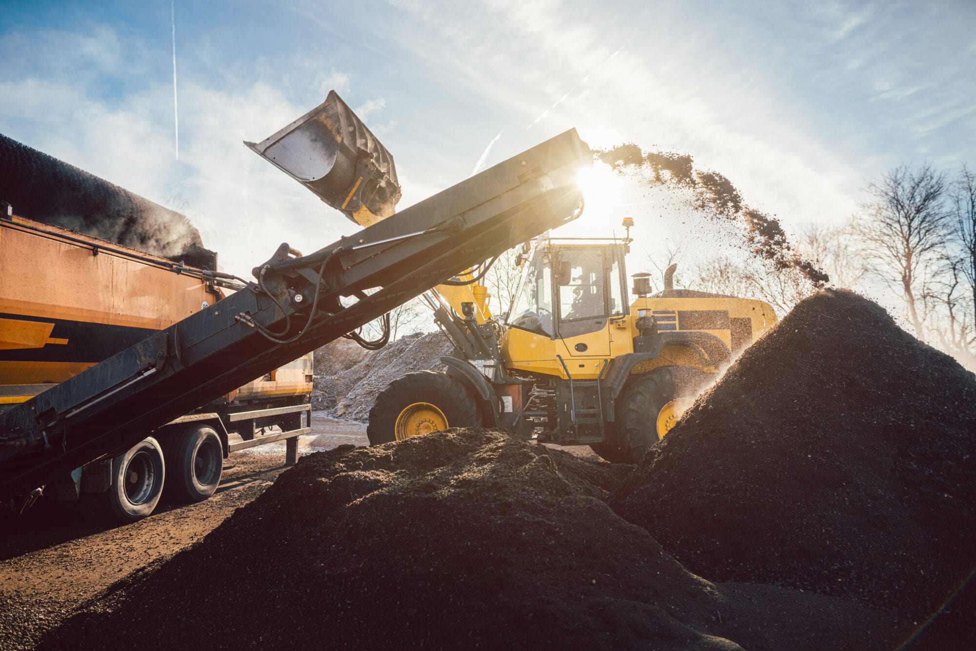 8ea91900-heavy-machinery-moving-earth-and-biomass-in-compost-works-1218842839-min