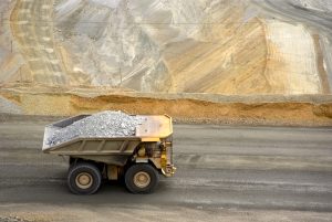 Yellow-large-dump-truck-in-Utah-copper-mine-seen-from-above-157501301-scaled-1