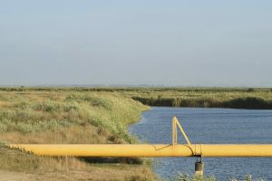 a2294c27-the-gas-pipeline-through-the-small-river-869302662