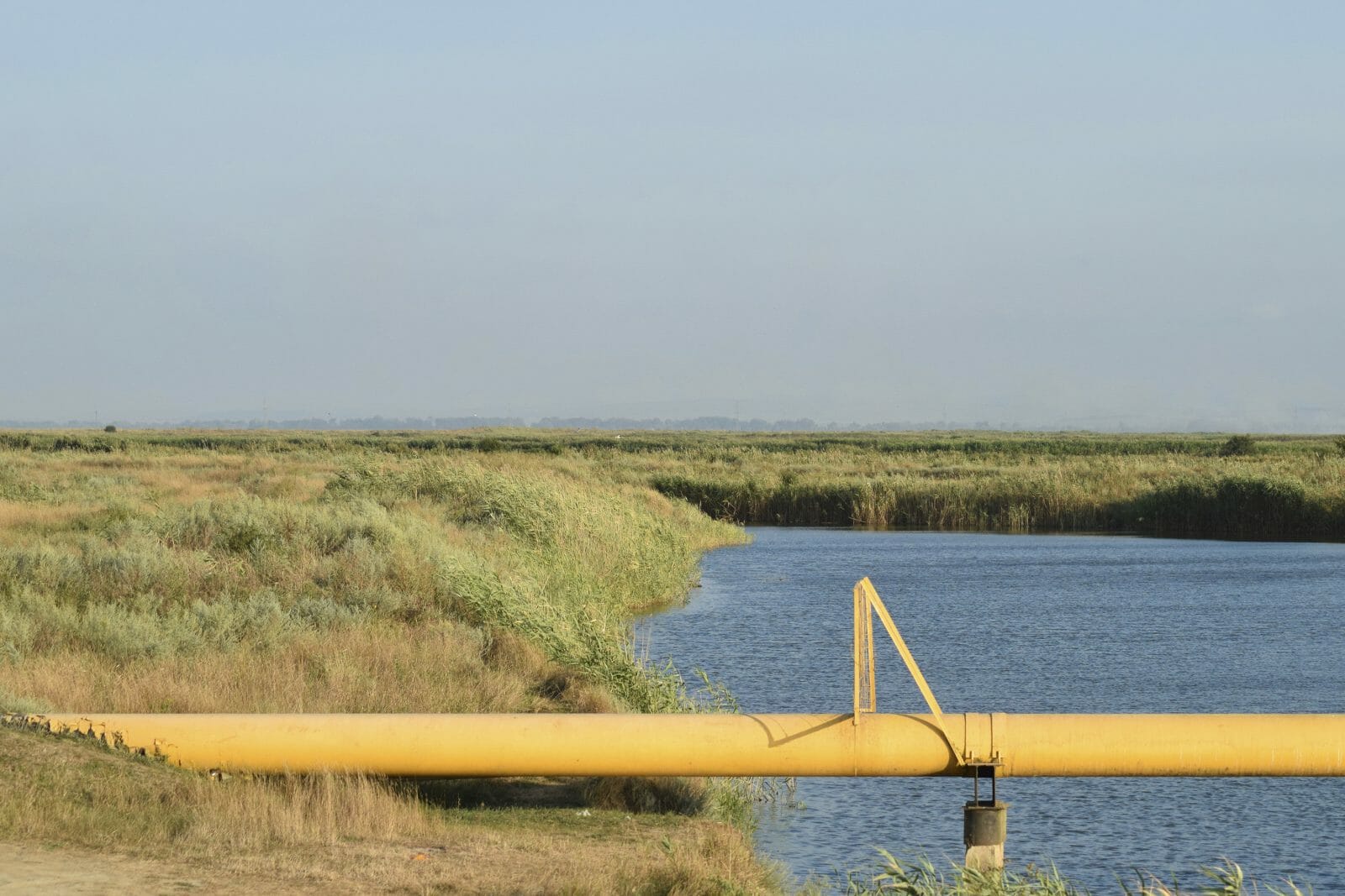 a2294c27-the-gas-pipeline-through-the-small-river-869302662