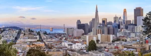 c137b482-san-francisco-skyline-panorama-at-sunset-with-bay-bridge-and-downtown-skyline-1212646618-1440x539-1