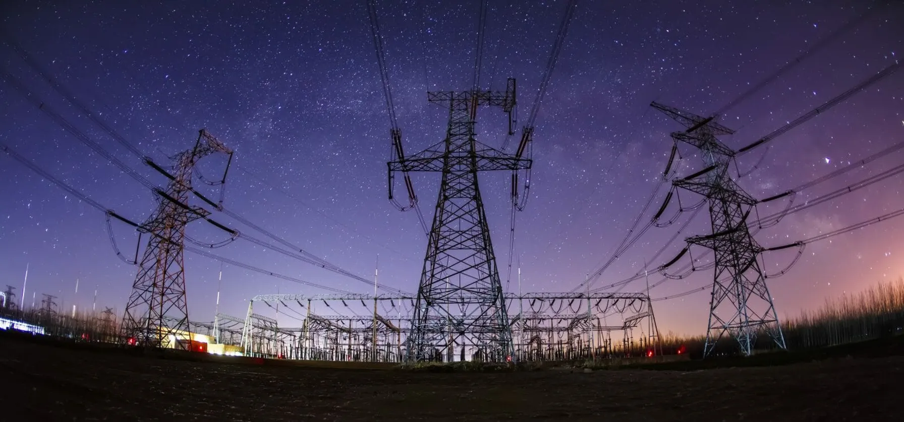 bb97855c-trc-linehub-hero-high-voltage-towers-at-night