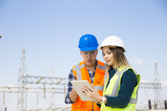 Engineers in front of power plant.
