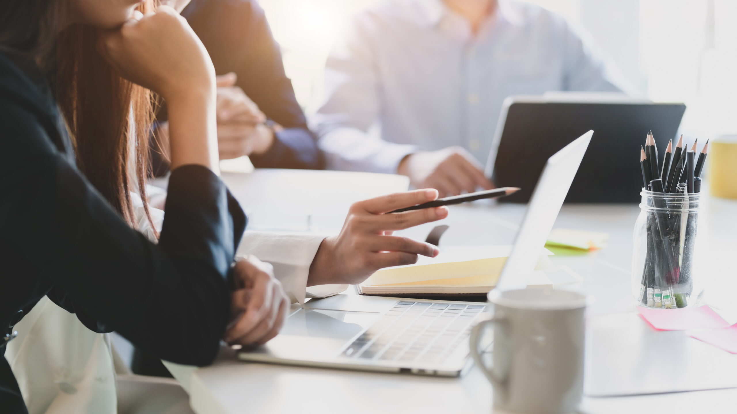 Cropped-shot-of-business-team-analysing-on-their-project-in-comfortable-meeting-room-1199568766-scaled