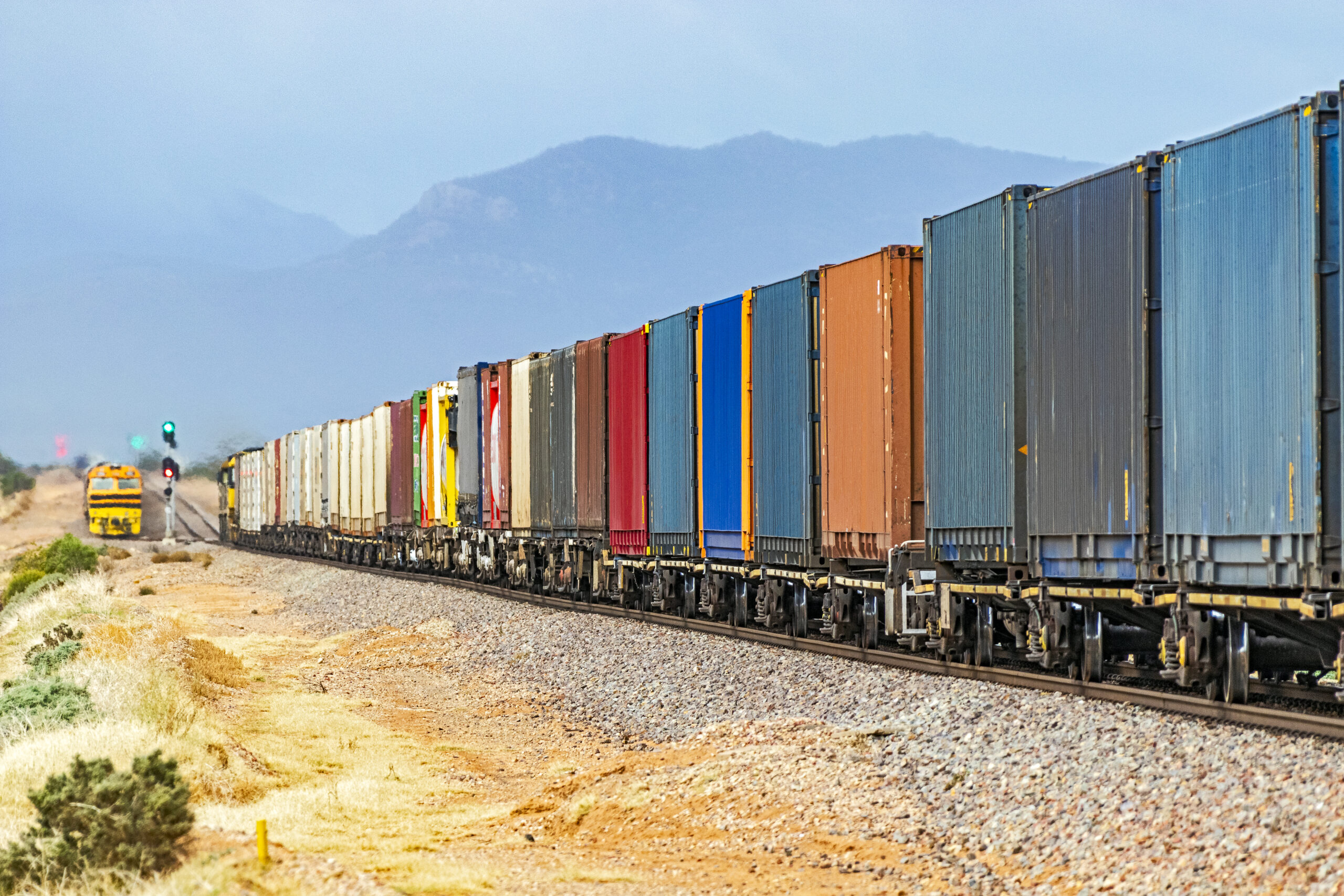 colourful-container-freight-train-1266439816-1-scaled